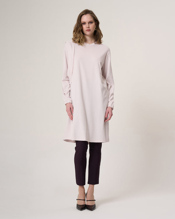 35025 beige longline tunic with a round neckline, curved seam detail and gathered cuffs, front view